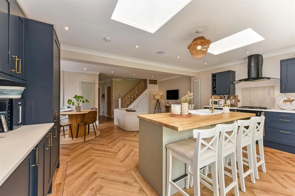 Open-plan kitchen and living space with island and roof lanterns